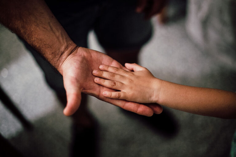 child support assessment - a picture of holding hands of a dad and daughter